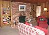 Third view - Main level - Living room with TV/VCR/DVD, wood burning fireplace, CD player plus some games & books for your enjoyment.