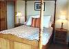 Upper level - Bedroom with a Queen bed, door to private deck and spectacular ocean views.