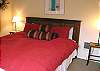 Upper level Master Bedroom with a King bed, TV and slider to deck.