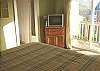 Second view - Lower level - Master Bedroom with a King bed, TV/DVD, slider out to deck and ocean views.  Private bathroom with a tub and shower.
