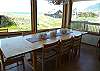 Upper level - Dining table for 10 with ocean views and door out to wrap around deck.