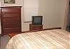 Second view - Lower level - Bedroom with a Queen bed and TV with a walk-in closet with games.