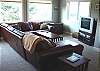 Upstairs living room with leather sectional and TV/DVD/VCR - has adjoining seating area
