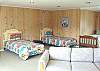 Upper level - Large bedroom with four twins, a hide-a-bed for additional sleeping and a TV/VCR - Great room for the kids!