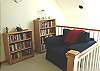 Upper level reading corner with comfy chair and lots of books!