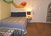 Lower level - Bedroom with a Double size bed and TV with slider out to backyard.