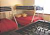 Lower level bedroom with Two Twin/Double Bunk beds, foos ball table and wall mount TV/VCR.