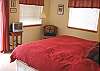 Second view of Upper level Master Bedroom with a King bed, TV and slider to deck.