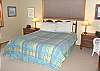 Master Bedroom with Queen Bed and TV.