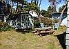 View of grassy backyard with picnic table.