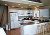 Upper level - Fully equipped kitchen with breakfast bar for 4 and ocean views.