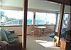 Lower level - Sitting/Sun room with couch, love seat, table for addtional dining for 2 and slider to deck with hot tub.