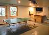 Fully finished garage with ping pong table.