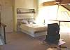 Upper level - Loft style bedroom with a Queen bed, TV/DVD, futon for additional sleeping and full office with DSL.