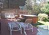 Back deck with patio furniture, hot tub, gas BBQ and bunk house with twin bunk bed.