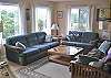 Second view - Upper level - Living room with futon for additional sleeping, TV/VCR/DVD and glass front wood stove.