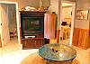 Second view - Lower level - Family room with love seat, wood stove and TV/VCR/DVD.