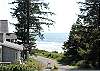 Ocean View taken from inside the house-living/dining room - your beach access path is just to the left of the trees.