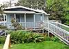 Wrap around deck with ocean views with Charcoal BBQ and patio furniture.