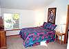 Upper level - Bedroom with Queen bed, TV/VCR/DVD and door to east facing deck.