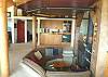 Living room with circular seating area, fireplace, wet bar and TV