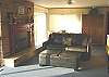 Third view - Living room with TV/VCR/DVD, gas fireplace and futon for additional sleeping.