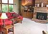 Second view - Upper level - Living room with large sectional, TV/VCR/DVD, wood stove insert, large picture windows with spectacular ocean views.