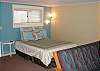 Lower level - Studio with a Queen bed and bathroom with a tub and shower.