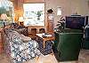 Upstairs living room with Large screen TV/DVD, fireplace and partial ocean views