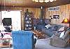 Living room featuring beautiful ocean views, TV/VCR/DVD, Hide-a-bed for addtional sleeping and a wood stove.