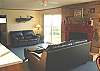 Second view - Living room with TV/VCR/DVD, gas fireplace and futon for additional sleeping.
