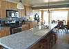 Third view - Fully equipped kitchen looking into dining area.