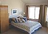 Middle level - Large master bedroom with Queen bed, TV//VCR/DVD, ocean view and slider to large west facing deck. Private bathroom with shower and a large walk-in closet.