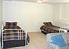 Third view - Lower Level - Large Family room with two couches and two day/trundle beds.