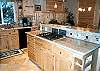 Second view of fully equipped kitchen with gas cook top