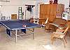 Garage with Ping Pong table, card table and wicker furniture for comfort.
