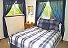 Upper level - Bedroom with a Queen bed and a skylight.