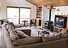 Upper level - Living room with TV/DVD/VCR, bench seat with puzzels & games and a glass front wood stove.