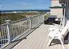 South facing deck with picnic table and deck chairs.