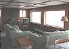 Lower level-Living room with TV/DVD/VCR, wood stove and ocean views.