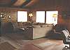 Living room with a wrap around sectional couch, flat screen TV/DVD, wood burning fireplace and ocean views.