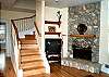 View of Double sided fireplace and stairs to upper level