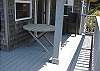 Third view - Upper level deck off living room with spectacular ocean views and a table with deck chairs.