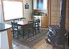 Upper level - Dining table for 6 with wood stove and beautiful ocean views.