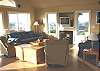 Upper level - Living room with TV/VCR/DVD, gas fireplace, hide a bed for additional sleeping and spectacular ocean views.