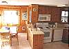 Second view of downstairs fully equipped kitchen and dining room.