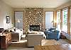 Lower level - Living room with gas fireplace and view of 9th Fairway of the golf course.