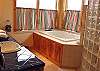 Lower level - Master Bathroom with Jacuzzi tub, large glass shower, double sinks and ocean views.
