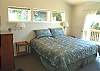 Master bedroom with a King bed, TV and slider out to private back deck with private bathroom with Jacuzzi tub and shower.