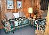 Lower level bedroom with Two Twin beds with a bookcase full of books.